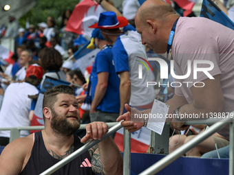 PARIS, FRANCE - JULY 08:
Piotr Malachowski (R), a Polish retired discus thrower, chatting with Pawel FAJDEK (L), during the Men's Hammer Thr...