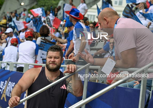 PARIS, FRANCE - JULY 08:
Piotr Malachowski (R), a Polish retired discus thrower, chatting with Pawel FAJDEK (L), during the Men's Hammer Thr...