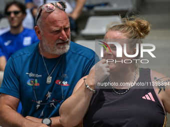 PARIS, FRANCE - JULY 08:
Alexandra TAVERNIER of France, with her father and coach, Christophe TAVERNIER, during the Women's Hammer Throw, at...