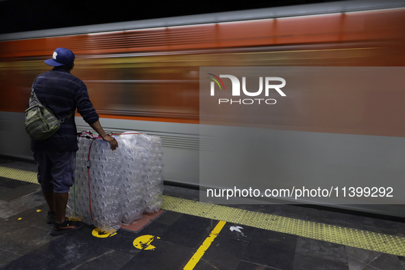 A person is waiting with packaging to board a metro train in Mexico City, Mexico, on june 10, 2024. 