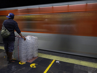 A person is waiting with packaging to board a metro train in Mexico City, Mexico, on june 10, 2024. (