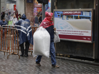 A person is walking in the rain on the streets of Mexico City, Mexico, on june 10, 2024. (