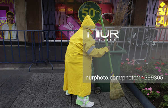 A person is walking in the rain on the streets of Mexico City, Mexico, on june 10, 2024. 