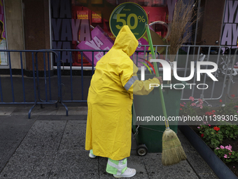 A person is walking in the rain on the streets of Mexico City, Mexico, on june 10, 2024. (