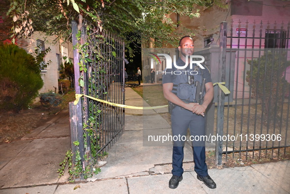 A police officer is standing guard at the crime scene. One person is shot and killed in Washington, D.C., United States, on July 10, 2024. O...