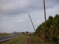 A row of power line support poles is falling along FM-3005 in Galveston, Texas, on July 10, 2024, in the wake of Hurricane Beryl. 1.1 millio...