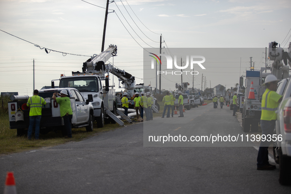 Electrical linemen are assembling near FM-3005 in Galveston, Texas, on July 10, 2024. 1.1 million Texans in and around the Houston area are...