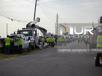 Electrical linemen are assembling near FM-3005 in Galveston, Texas, on July 10, 2024. 1.1 million Texans in and around the Houston area are...