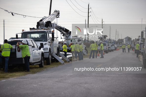 Electrical linemen are assembling near FM-3005 in Galveston, Texas, on July 10, 2024. 1.1 million Texans in and around the Houston area are...