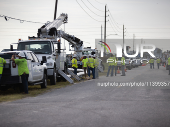 Electrical linemen are assembling near FM-3005 in Galveston, Texas, on July 10, 2024. 1.1 million Texans in and around the Houston area are...