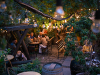 People are staying at an outdoor cafe in a courtyard in Lviv, Ukraine, on July 5, 2024. NO USE RUSSIA. NO USE BELARUS. (