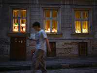 Lamps made of stained glass are on display in the windows of architect Pavlovsky's studio during a power outage at night in Lviv, Ukraine, o...