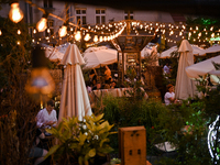 People are staying at an outdoor cafe in a courtyard in Lviv, Ukraine, on July 5, 2024. NO USE RUSSIA. NO USE BELARUS. (