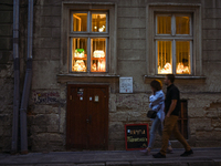 Lamps made of stained glass are on display in the windows of architect Pavlovsky's studio during a power outage at night in Lviv, Ukraine, o...