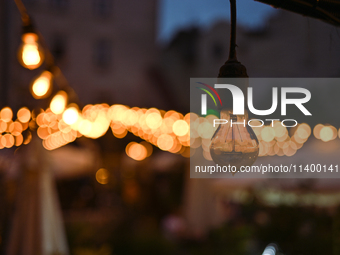 A light bulb is hanging in one of the outdoor cafes in Lviv, Ukraine, on July 5, 2024. NO USE RUSSIA. NO USE BELARUS. (