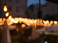 A light bulb is hanging in one of the outdoor cafes in Lviv, Ukraine, on July 5, 2024. NO USE RUSSIA. NO USE BELARUS. (