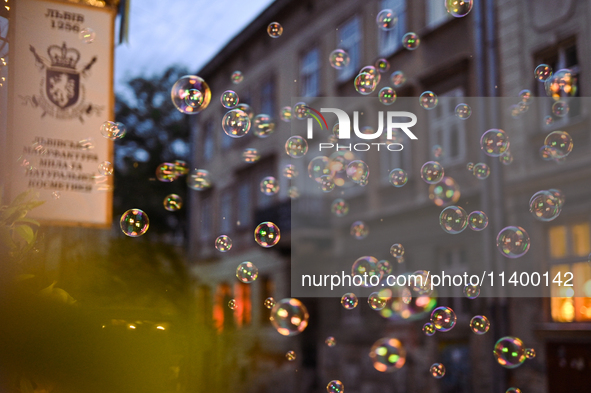 Soap bubbles are capturing light near the Lviv Soap Workshop in Lviv, Ukraine, on July 5, 2024. NO USE RUSSIA. NO USE BELARUS. 