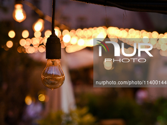 A light bulb is hanging in one of the outdoor cafes in Lviv, Ukraine, on July 5, 2024. NO USE RUSSIA. NO USE BELARUS. (