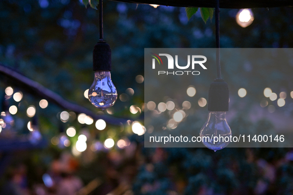 Light bulbs are being used as part of string lights at an outdoor cafe in Lviv, Ukraine, on July 5, 2024. NO USE RUSSIA. NO USE BELARUS. 