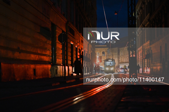 A tram is running in Katedralna Square at night in Lviv, Ukraine, on July 5, 2024. NO USE RUSSIA. NO USE BELARUS. 