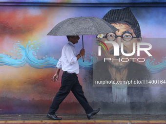 People are taking shelter from the rain in Kathmandu, Nepal, on July 11, 2024, after the reactivation of the monsoon climatic effect in the...