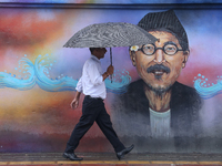 People are taking shelter from the rain in Kathmandu, Nepal, on July 11, 2024, after the reactivation of the monsoon climatic effect in the...