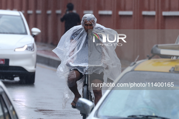 People are taking shelter from the rain in Kathmandu, Nepal, on July 11, 2024, after the reactivation of the monsoon climatic effect in the...