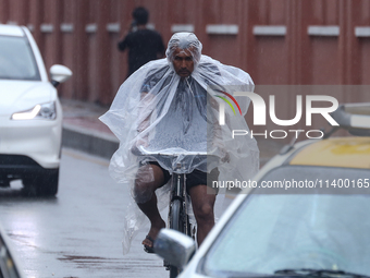 People are taking shelter from the rain in Kathmandu, Nepal, on July 11, 2024, after the reactivation of the monsoon climatic effect in the...