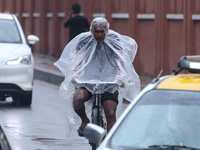 People are taking shelter from the rain in Kathmandu, Nepal, on July 11, 2024, after the reactivation of the monsoon climatic effect in the...