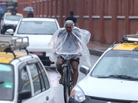 People are taking shelter from the rain in Kathmandu, Nepal, on July 11, 2024, after the reactivation of the monsoon climatic effect in the...