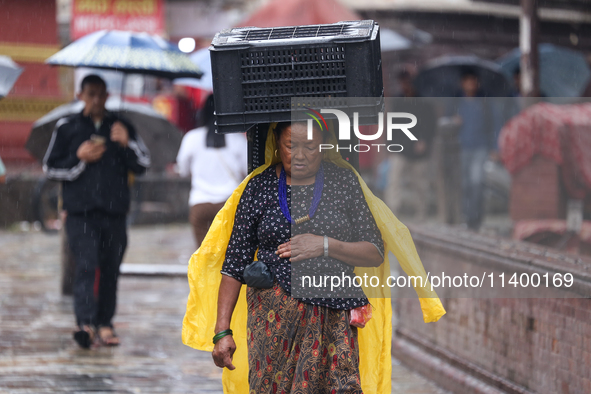 People are taking shelter from the rain in Kathmandu, Nepal, on July 11, 2024, after the reactivation of the monsoon climatic effect in the...