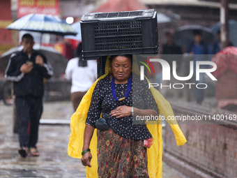 People are taking shelter from the rain in Kathmandu, Nepal, on July 11, 2024, after the reactivation of the monsoon climatic effect in the...