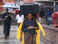 People are taking shelter from the rain in Kathmandu, Nepal, on July 11, 2024, after the reactivation of the monsoon climatic effect in the...