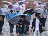 People are taking shelter from the rain in Kathmandu, Nepal, on July 11, 2024, after the reactivation of the monsoon climatic effect in the...