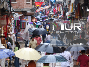 A marketway in Kathmandu, Nepal, on July 11, 2024, is filling with umbrellas as rain continues to pour. Nepal is recording heavy rainfall si...