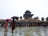 People are taking shelter under umbrellas as they walk in the rain in Kathmandu, Nepal, on July 11, 2024. Nepal is recording heavy rainfall...