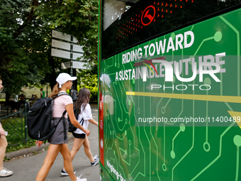 People pass as PEV9 King Long mini bus is presented for public by Barbican in Krakow, Poland on July 11, 2024. The bus will be included in K...