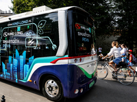 People pass as PEV6 King Long mini bus is presented for public by Barbican in Krakow, Poland on July 11, 2024. PEV6 will be included in Krak...