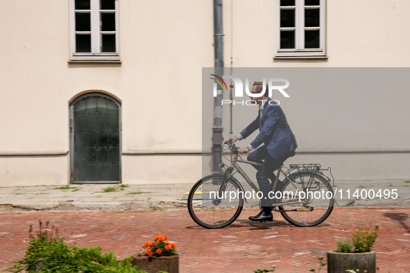 President of Krakow, Aleksander Misztalski arrives for a press conference on a bicycle to announce that Krakow joins The Milan Urban Food Po...