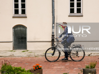 President of Krakow, Aleksander Misztalski arrives for a press conference on a bicycle to announce that Krakow joins The Milan Urban Food Po...