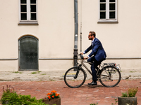 President of Krakow, Aleksander Misztalski arrives for a press conference on a bicycle to announce that Krakow joins The Milan Urban Food Po...