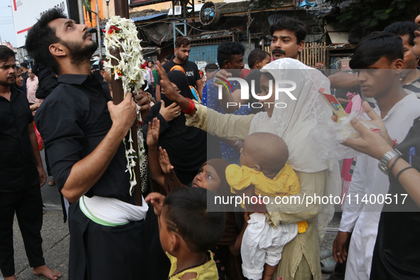 A Muslim devotee is participating in the 4th day of the Muharram festival in Kolkata, India, on July 11, 2024. 