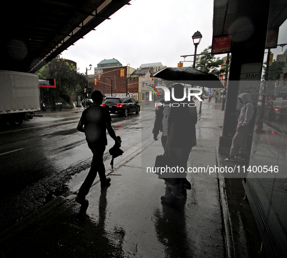 Pedestrians are walking along the street and waiting for public transportation on Main Street in Brampton, Ontario, on July 10, 2024. Remnan...