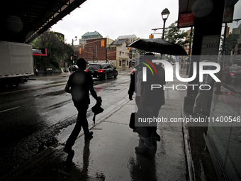 Pedestrians are walking along the street and waiting for public transportation on Main Street in Brampton, Ontario, on July 10, 2024. Remnan...