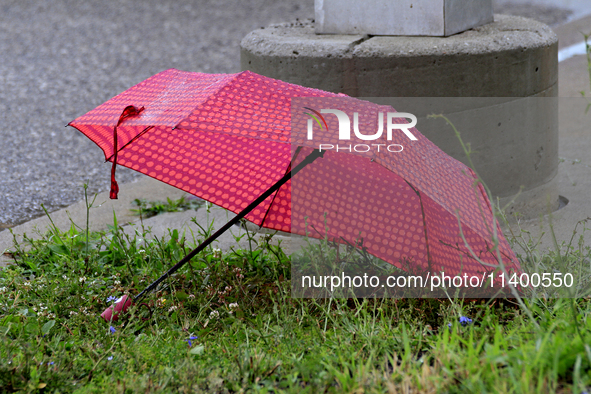 A discarded umbrella is lying near the Brampton Innovation District train station in Brampton, Ontario, on July 10, 2024. Remnants of Hurric...