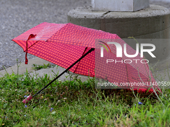 A discarded umbrella is lying near the Brampton Innovation District train station in Brampton, Ontario, on July 10, 2024. Remnants of Hurric...