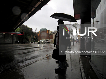 Pedestrians are waiting for public transportation on Main Street in Brampton, Ontario, on July 10, 2024. Remnants of Hurricane Beryl are pas...