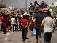 Displaced Palestinians, who are fleeing north Gaza after being ordered by the Israeli army to move southward amid the Israel-Hamas conflict,...