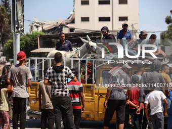 Displaced Palestinians, who are fleeing north Gaza after being ordered by the Israeli army to move southward amid the Israel-Hamas conflict,...