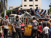 Displaced Palestinians, who are fleeing north Gaza after being ordered by the Israeli army to move southward amid the Israel-Hamas conflict,...